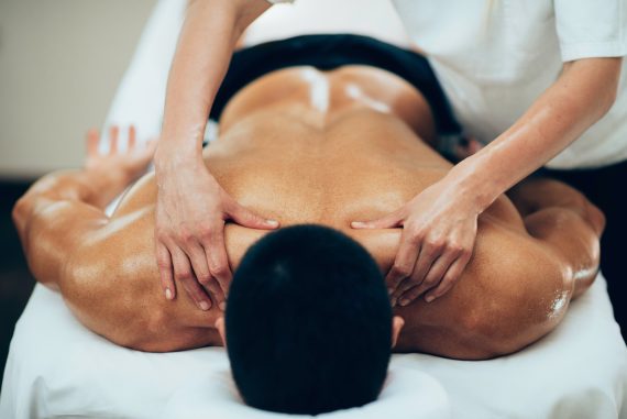 Sports massage. Therapist working with shoulders Sports massage. Therapist working with shoulders